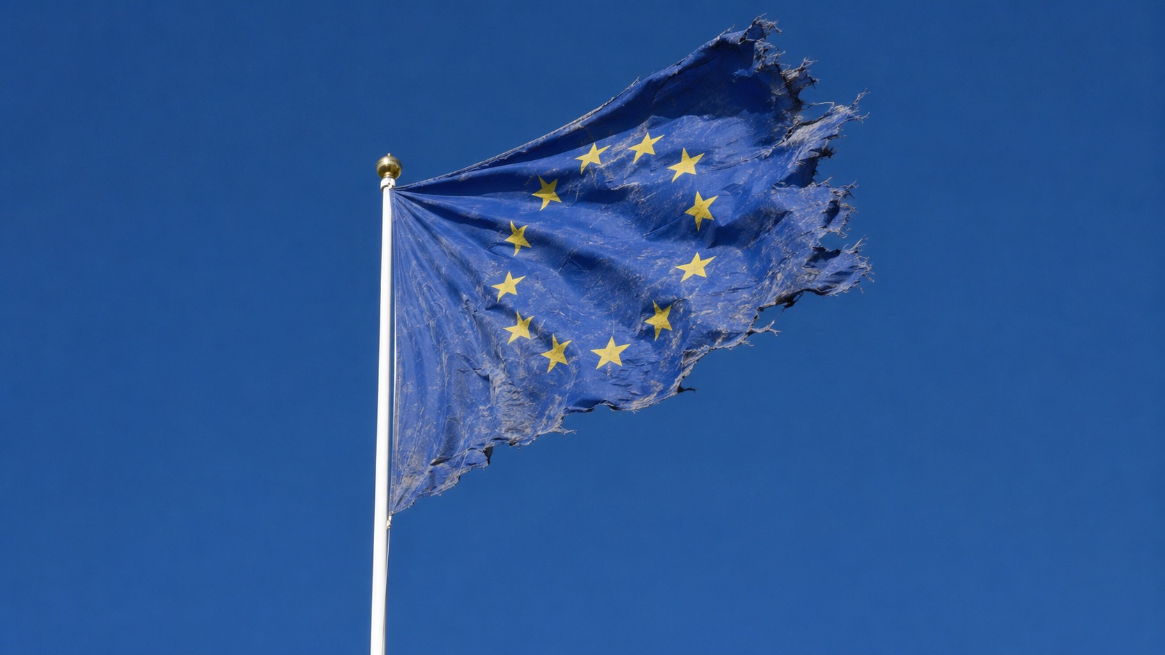A tattered European Union flag against a blue sky